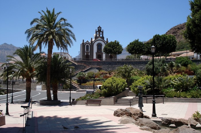 Church in a town square with palm trees, Spain