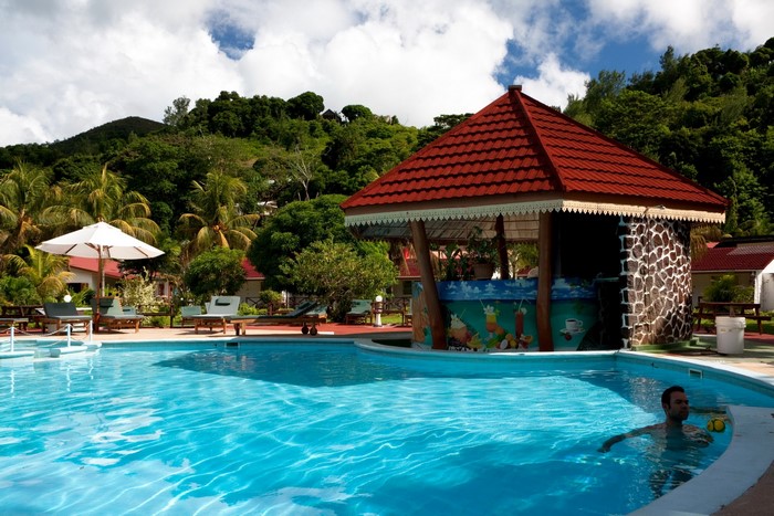 Resort pool with bar and tropical hills