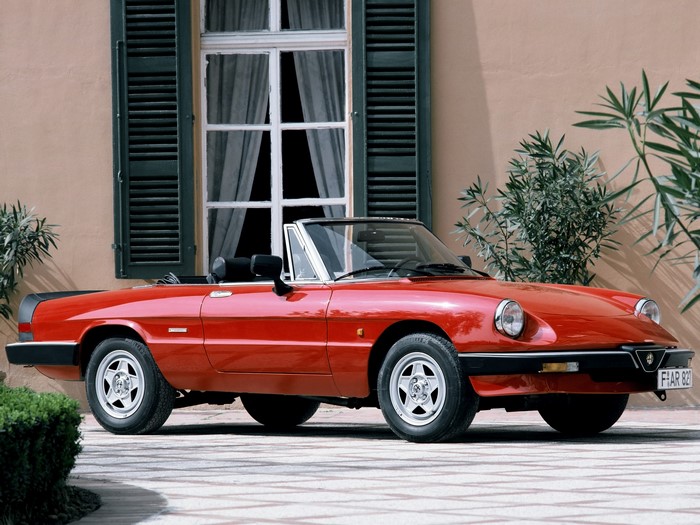 Red Alfa Romeo Spider convertible parked outdoors