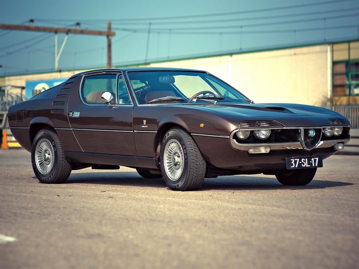 Brown Alfa Romeo Montreal parked on asphalt