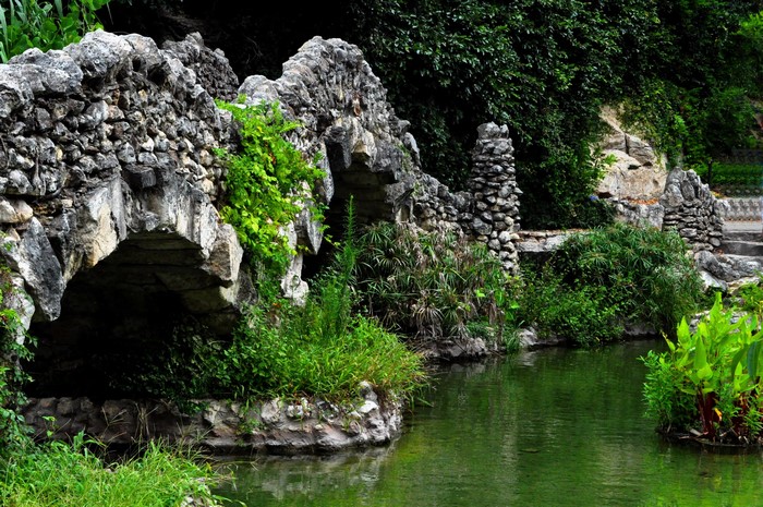 Stone bridge over a pond in a garden