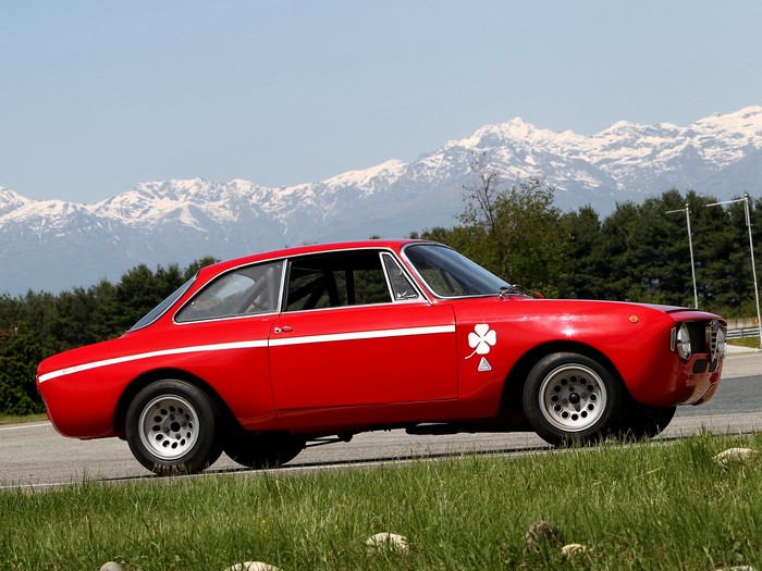 Red Alfa Romeo GT Veloce race car with clover emblem