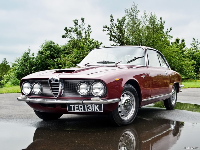 Maroon Alfa Romeo coupe on a wet road