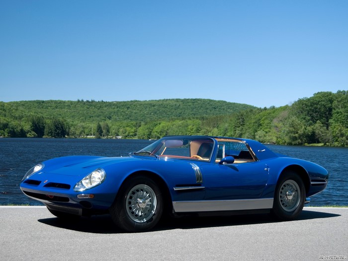 Blue Bizzarrini sports car by a lake