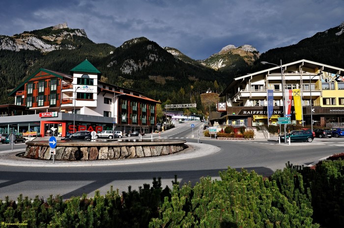 Roundabout in a mountain town with Spar and Raiffeisenbank