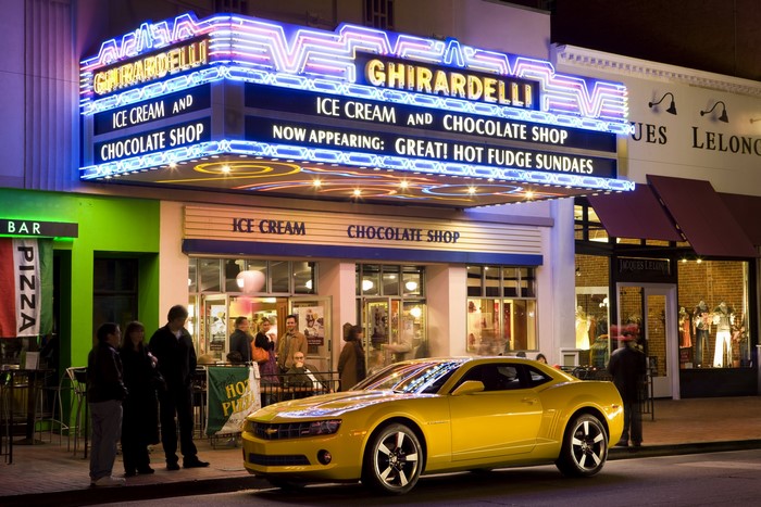 Yellow Chevrolet Camaro in front of Ghirardelli Ice Cream Shop