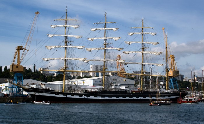 Tall Ship in a Harbor with Cranes