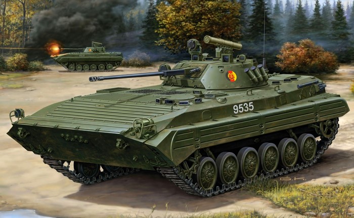 Two green armored vehicles in a forest setting