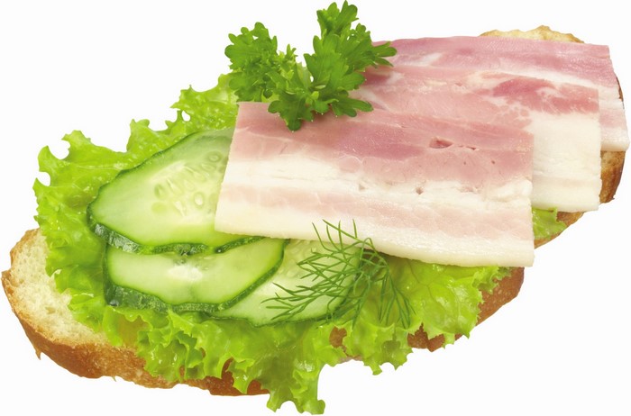 Sandwich with bacon, cucumber, lettuce, and herbs