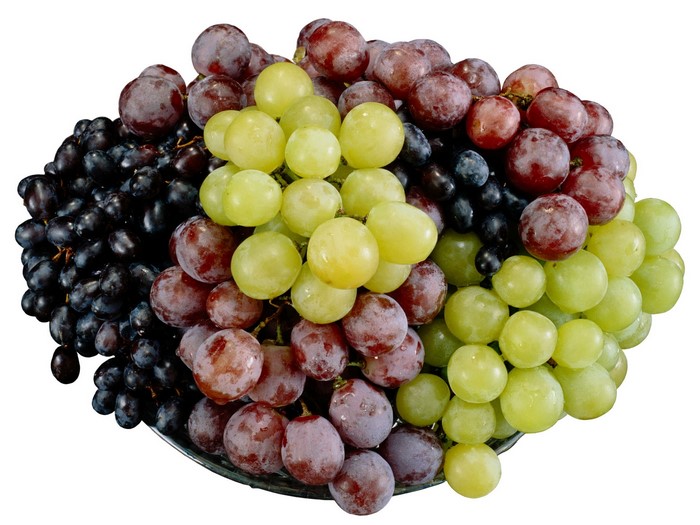 A bowl of red, green, and black grapes