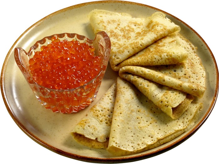 Pancakes with red caviar on a plate