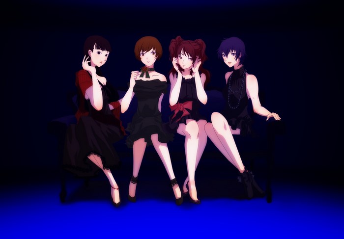 Four girls in black dresses sitting on a couch