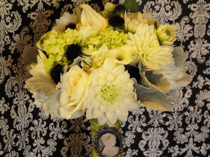Yellow and white floral bouquet with cameo brooch
