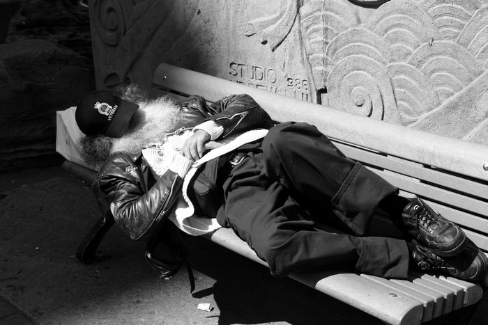 Man sleeping on a park bench