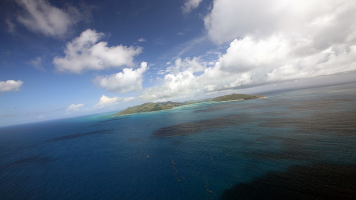 Aerial view of islands and ocean under a cloudy sky