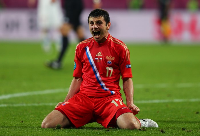 Football player in Russian uniform celebrating