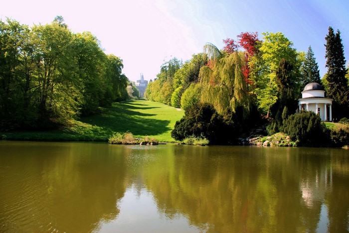 Park with a lake and a building