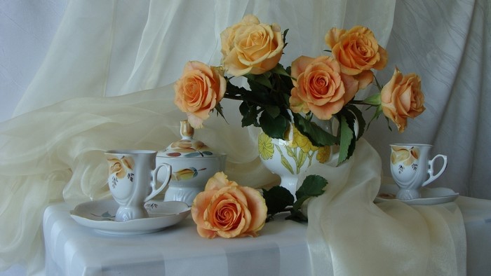 Still life with orange roses and tea set