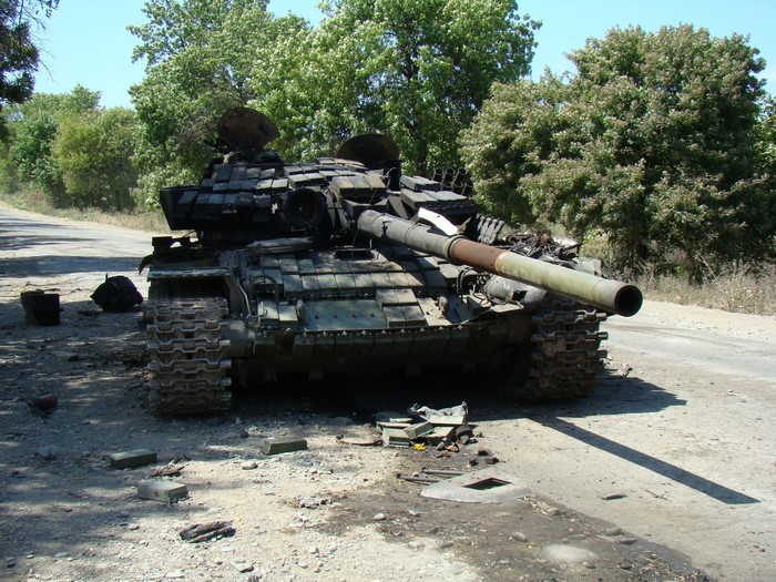 Destroyed tank on a dirt road
