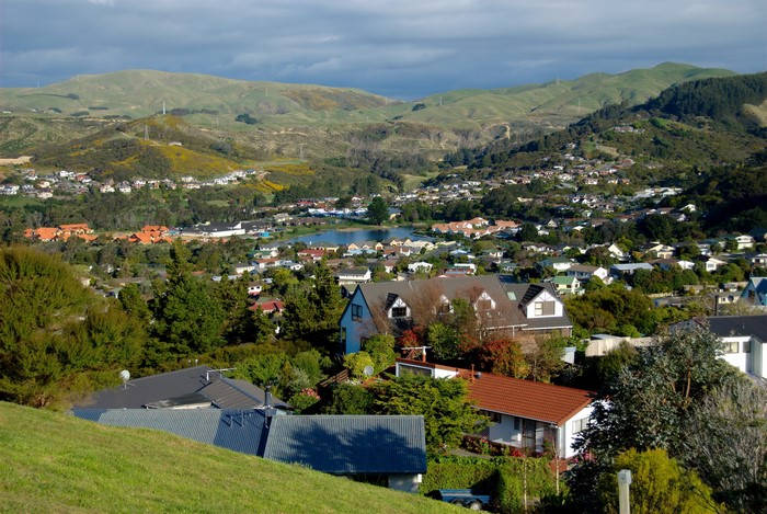 Suburban landscape with hills and a lake in Whitby, New Zealand