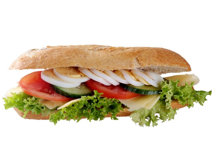 Sandwich with egg, cheese, tomato, cucumber, and lettuce