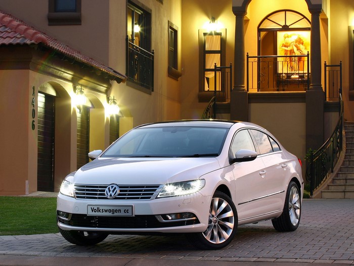 White Volkswagen CC parked in front of a house