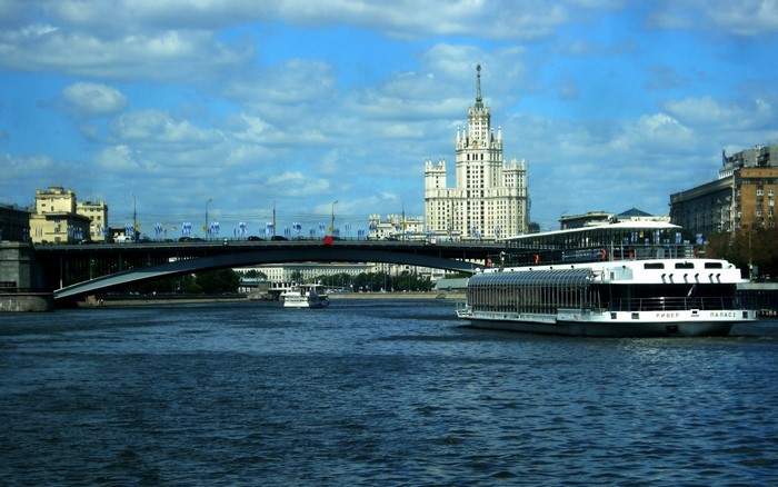 Stalinist skyscraper and river cruise ship in Moscow, Russia