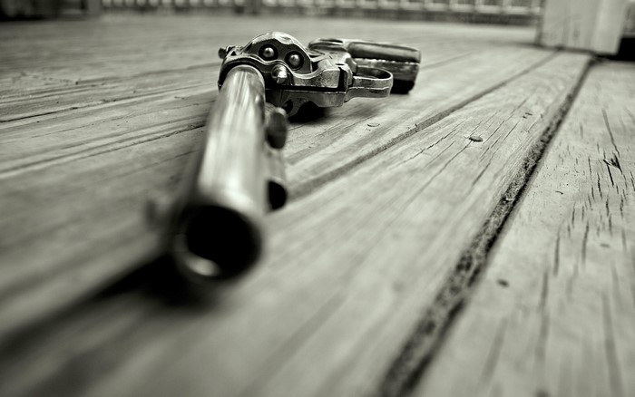 Revolver pistol lying on wooden planks