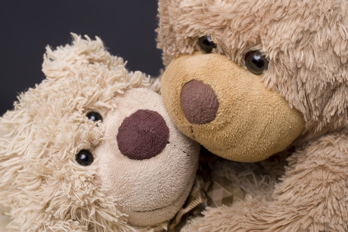 Two teddy bears hugging