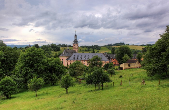 Monastery building with tower in a green landscape, Germany