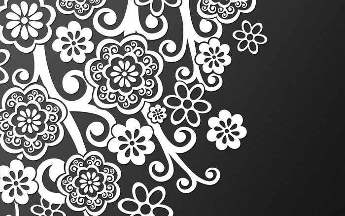 White floral tracery on a dark background