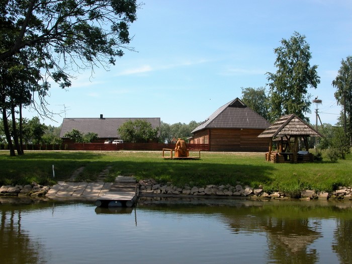 Wooden buildings and gazebo by a lake in the Baltics