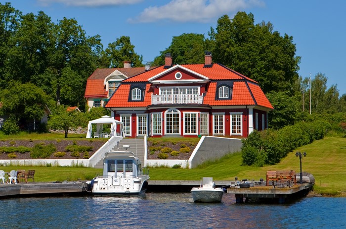 Red house with boats on the water in Sweden