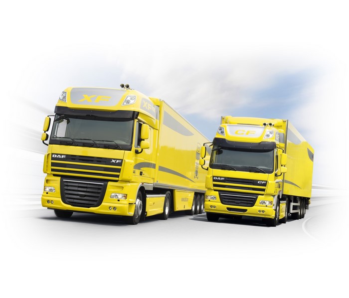 Two yellow DAF trucks on a white background