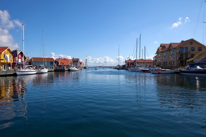 Colorful buildings and sailboats in a Swedish harbor