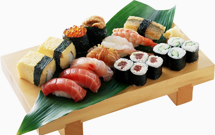 Assortment of sushi and sashimi on a wooden platter