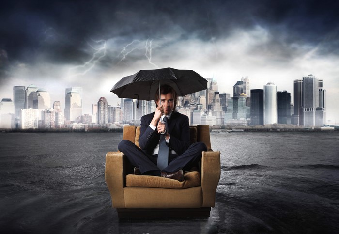 Man in Suit with Umbrella in Flooded City