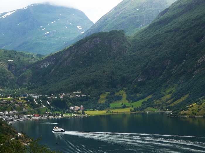 Ferry on Geiranger Fjord in Norway with Mountains