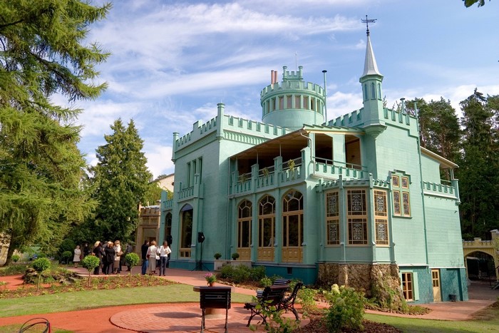 Mint green castle with turrets and balconies in Latvia