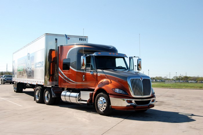 Orange and gray International semi-truck with trailer