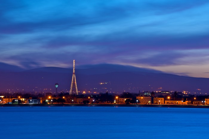 Cityscape with illuminated tower at dusk