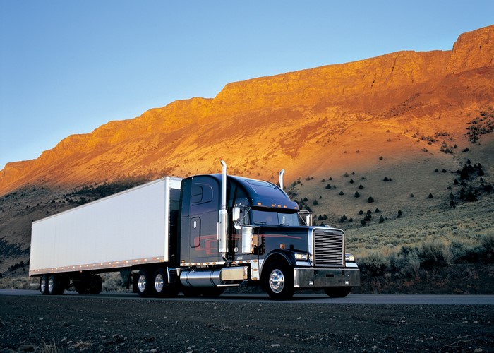 Freightliner semi-truck with trailer on a road