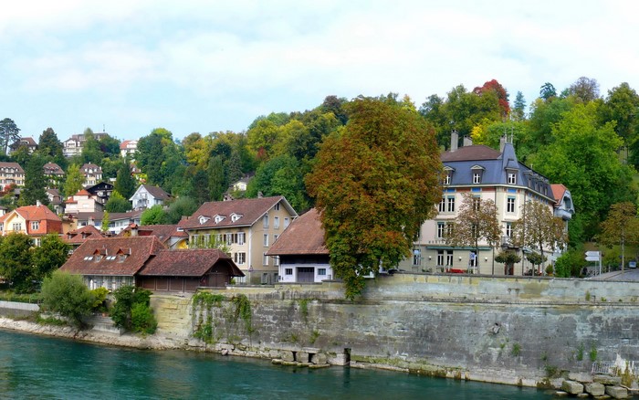 Buildings on a hillside overlooking a river in Switzerland