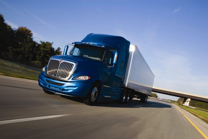 Blue International Semi-Truck Driving on Highway