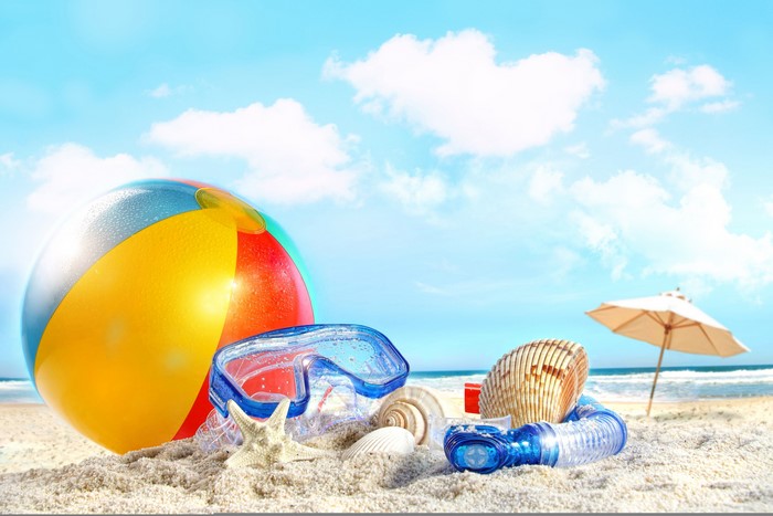Beach Ball, Snorkel Gear, and Seashells on Sandy Beach