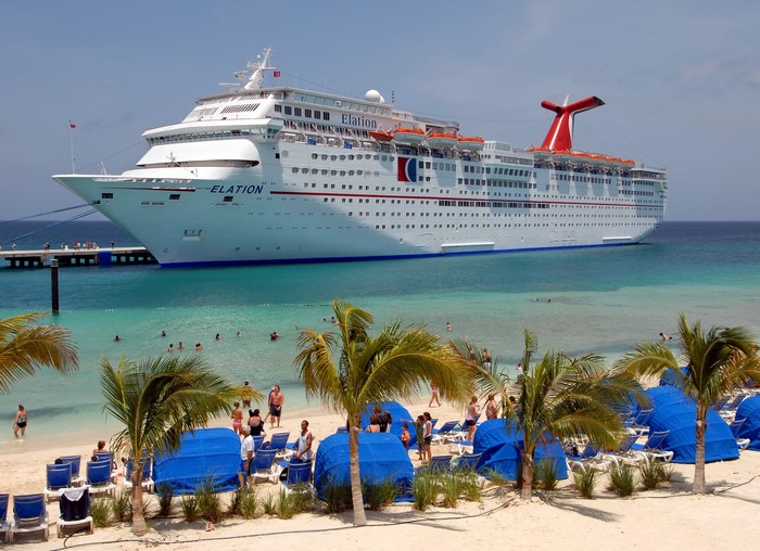 Carnival Elation cruise ship docked at a tropical beach
