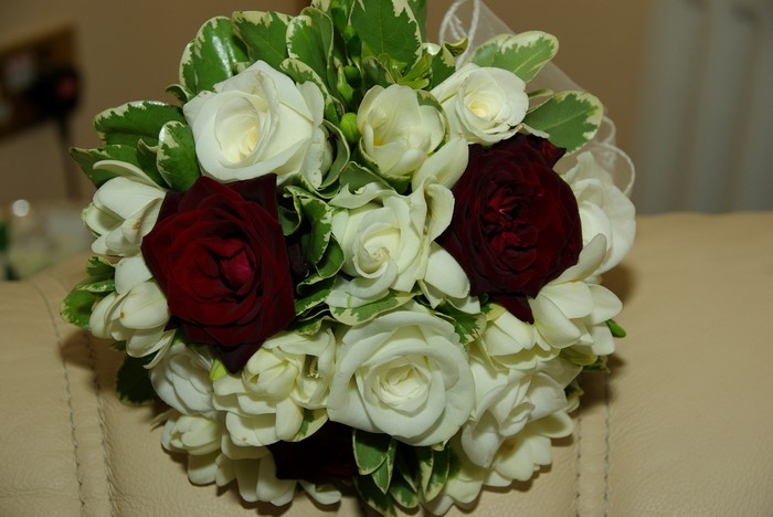 Bouquet of red and white roses with greenery