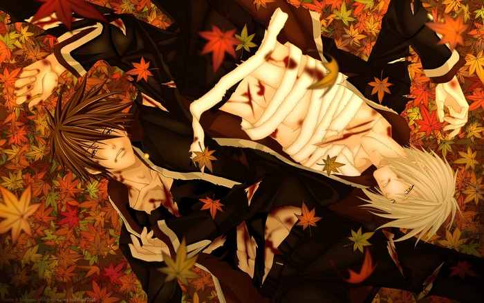 Two young men lying on autumn leaves