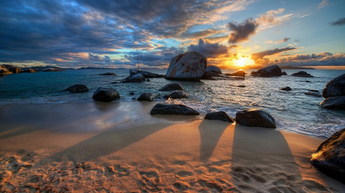 Sunset over rocky beach with ocean waves