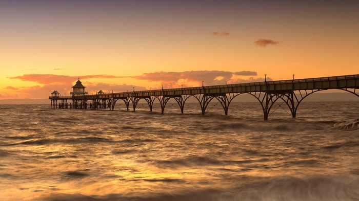 Pier over the ocean at sunset